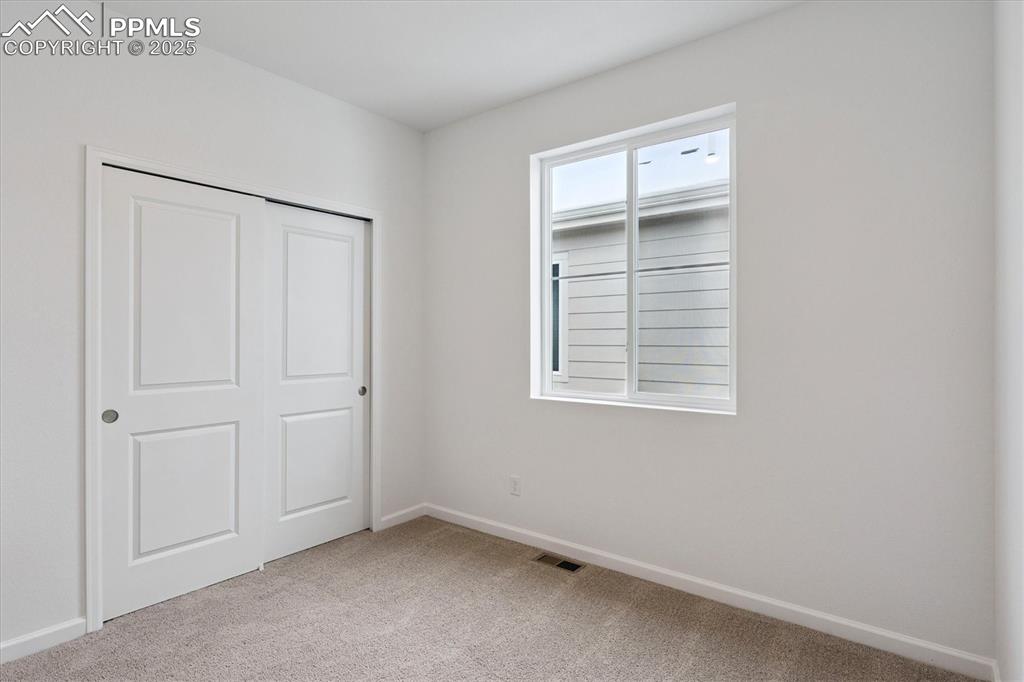 2444 Serviceberry Grove Colorado Springs, CO 80915 - Photo 15 of 21 an empty room with windows and closet