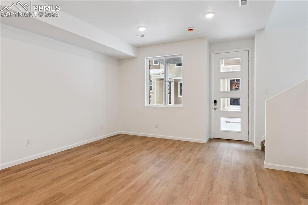 2444 Serviceberry Grove Colorado Springs, CO 80915 - Photo 3 of 21 a view of empty room with wooden floor