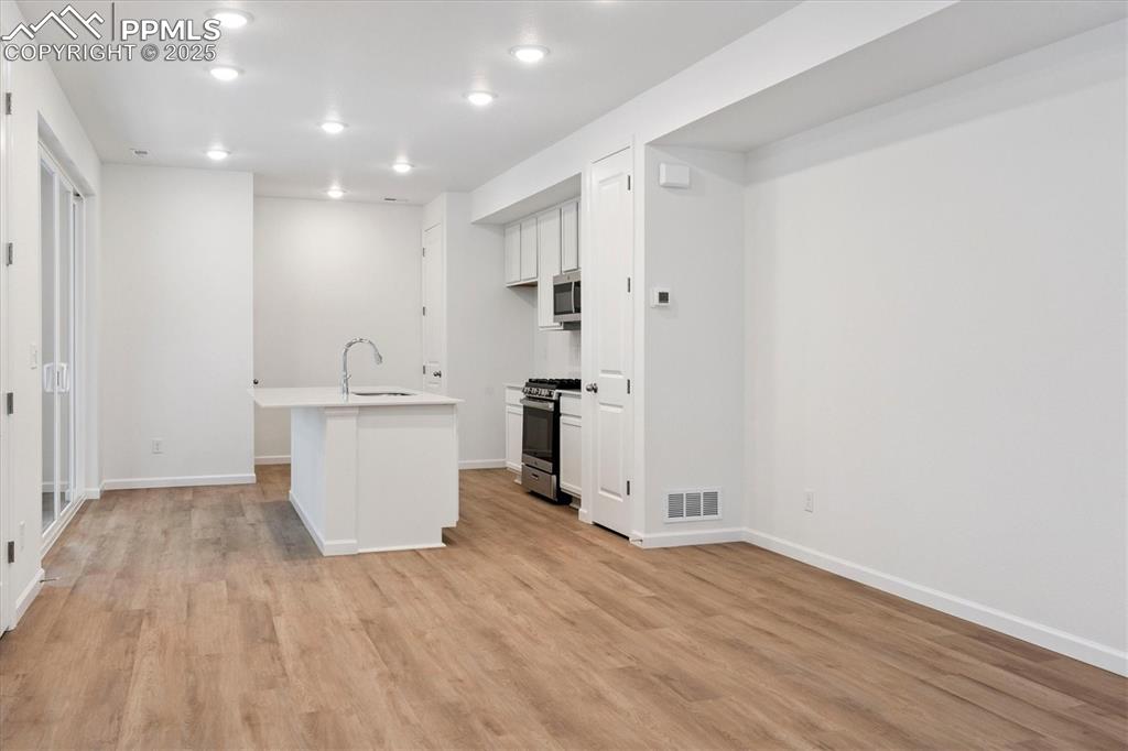 2444 Serviceberry Grove Colorado Springs, CO 80915 - Photo 4 of 21 a view of a kitchen with wooden floor
