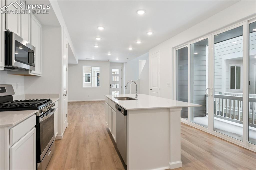 2444 Serviceberry Grove Colorado Springs, CO 80915 - Photo 7 of 21 a kitchen with stainless steel appliances granite countertop a stove and a sink