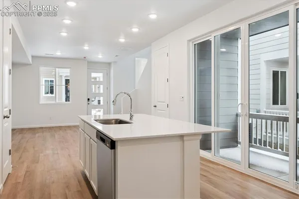 a kitchen that has a sink a window and cabinets