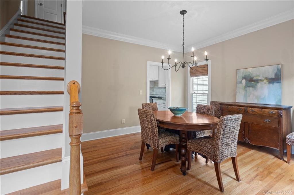 809 Millbrook Road Charlotte, NC 28211 - Photo 8 of 31 a dining room with furniture a chandelier and wooden floor