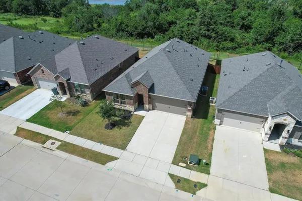 an aerial view of a house with a garden space