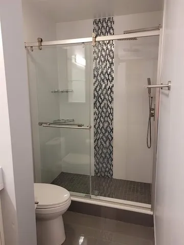 a bathroom with a toilet and shower