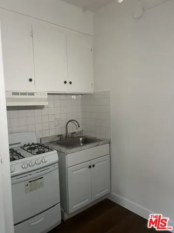 a bathroom with a shower sink and vanity