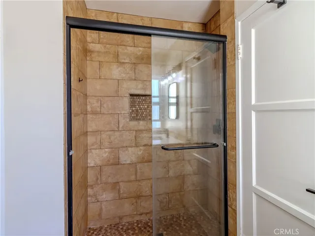 a bathroom with a glass shower door