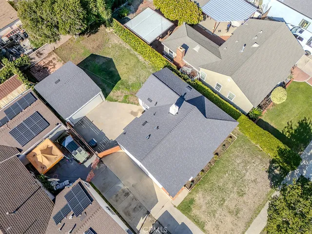 an aerial view of a house with a yard