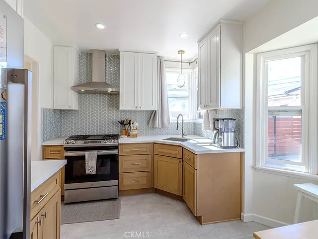 a kitchen with stainless steel appliances granite countertop a stove and a sink