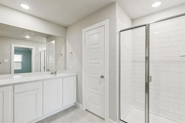 a bathroom with a mirror and a shower