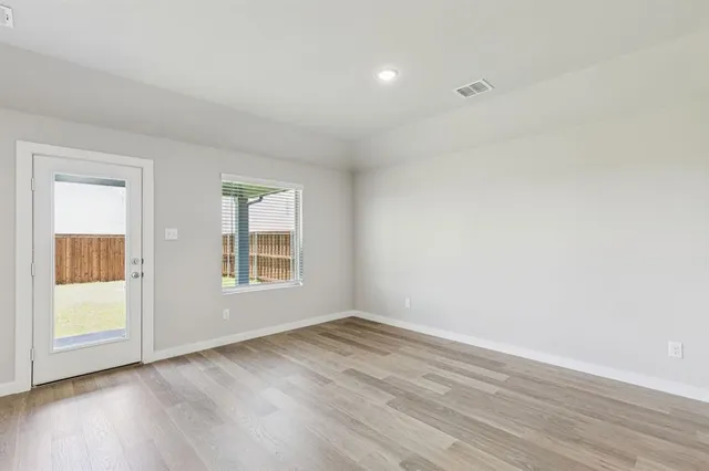 a view of kitchen with cabinets and wooden floor