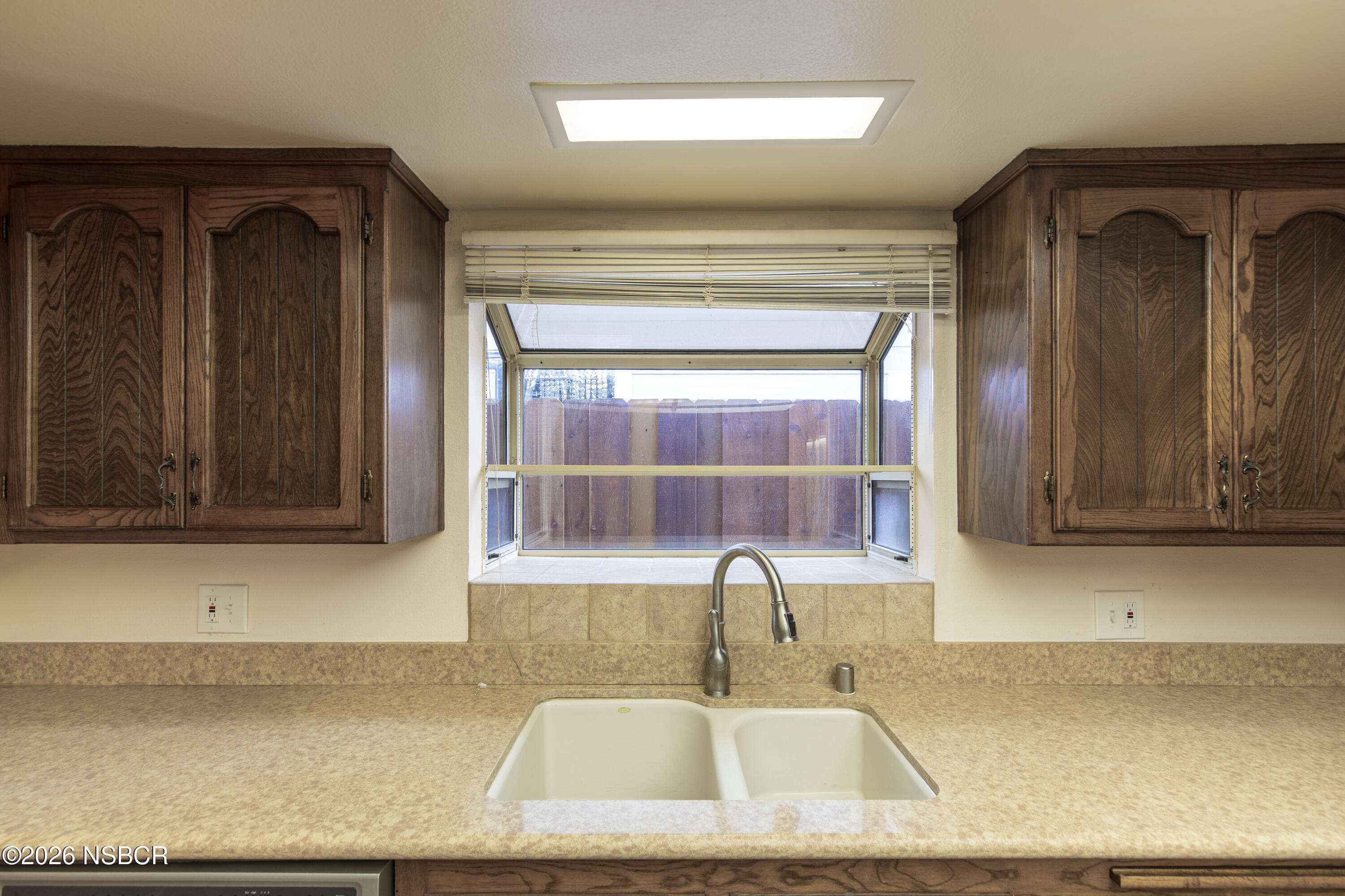 205 South E Street Lompoc, CA 93436 - Photo 11 of 49 a bathroom with a sink and a mirror