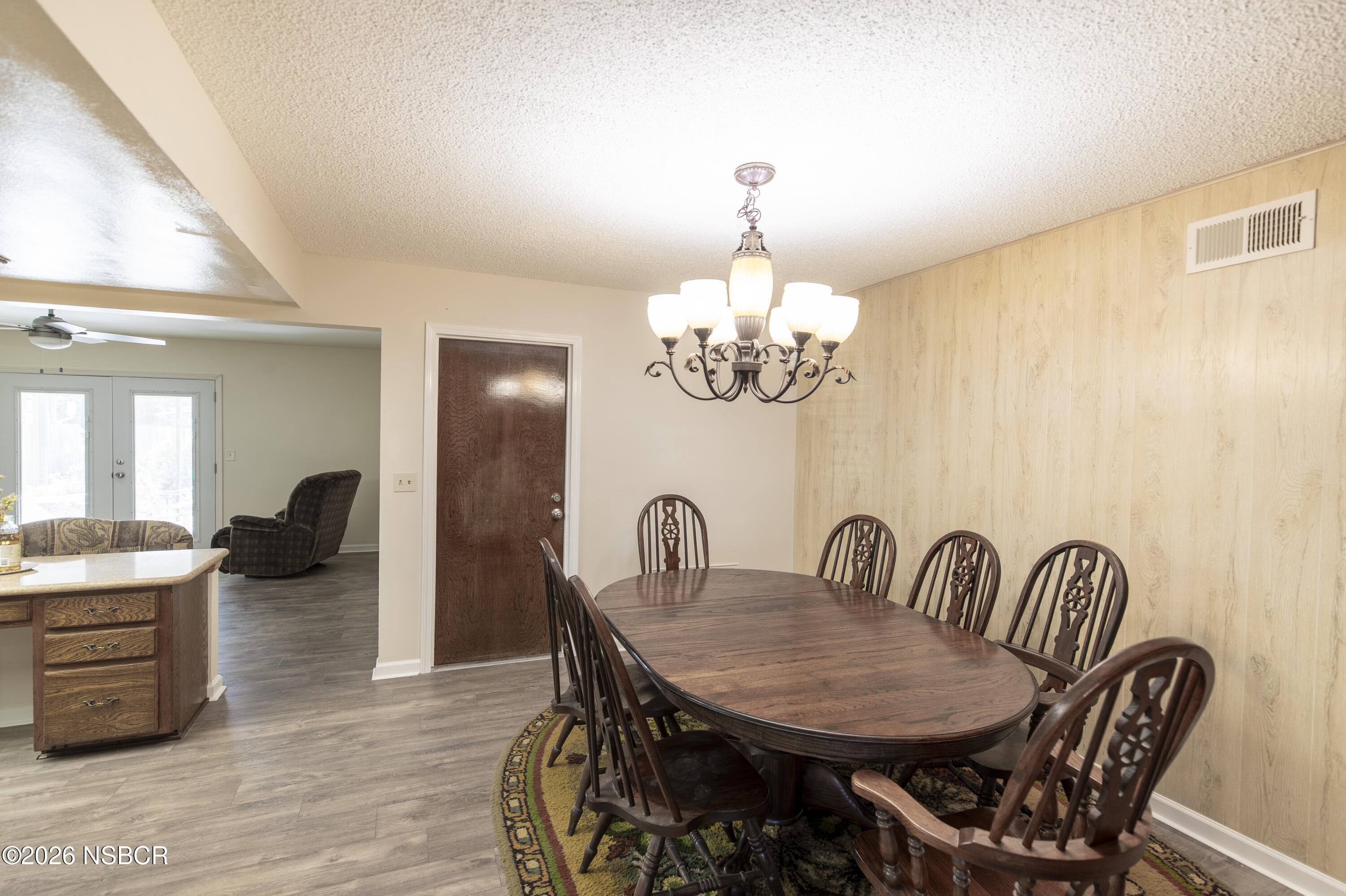 205 South E Street Lompoc, CA 93436 - Photo 15 of 49 a view of a dining room with furniture wooden floor and chandelier