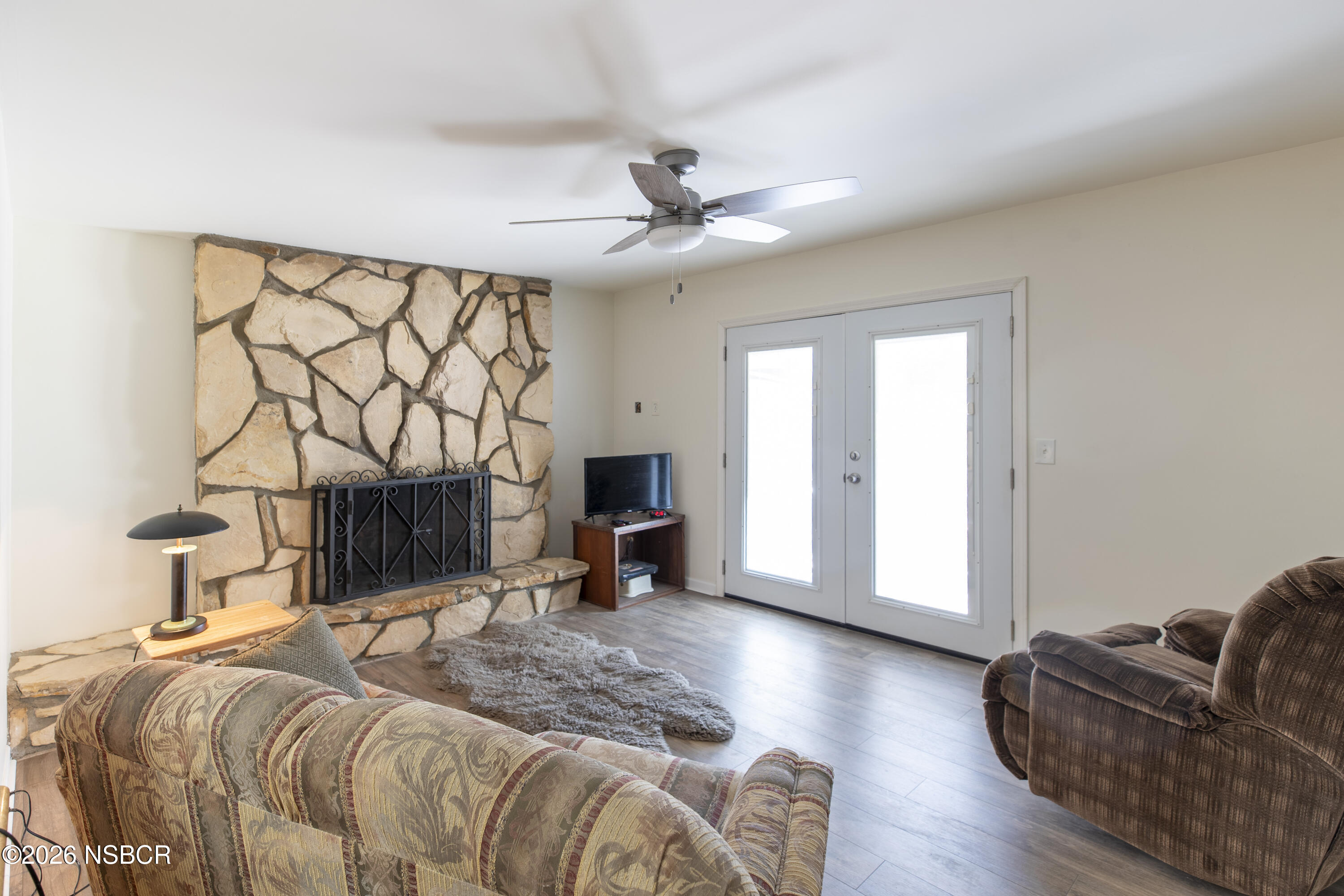 205 South E Street Lompoc, CA 93436 - Photo 17 of 49 a spacious bedroom with a bed a couch and dresser