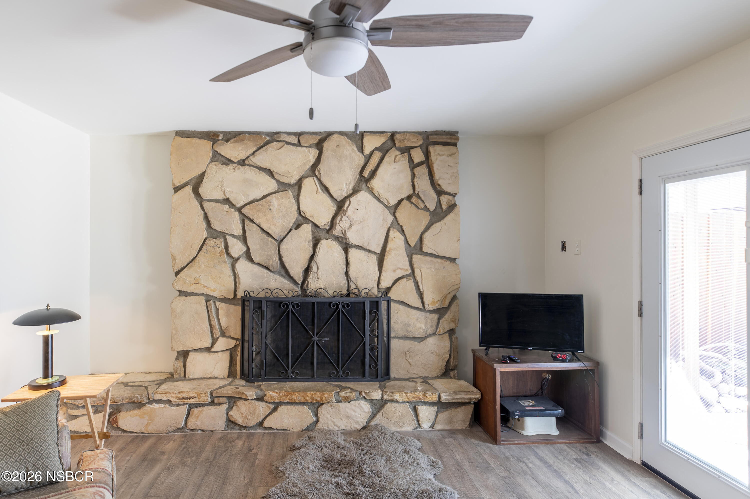 205 South E Street Lompoc, CA 93436 - Photo 18 of 49 a living room with a couch and a flat screen tv