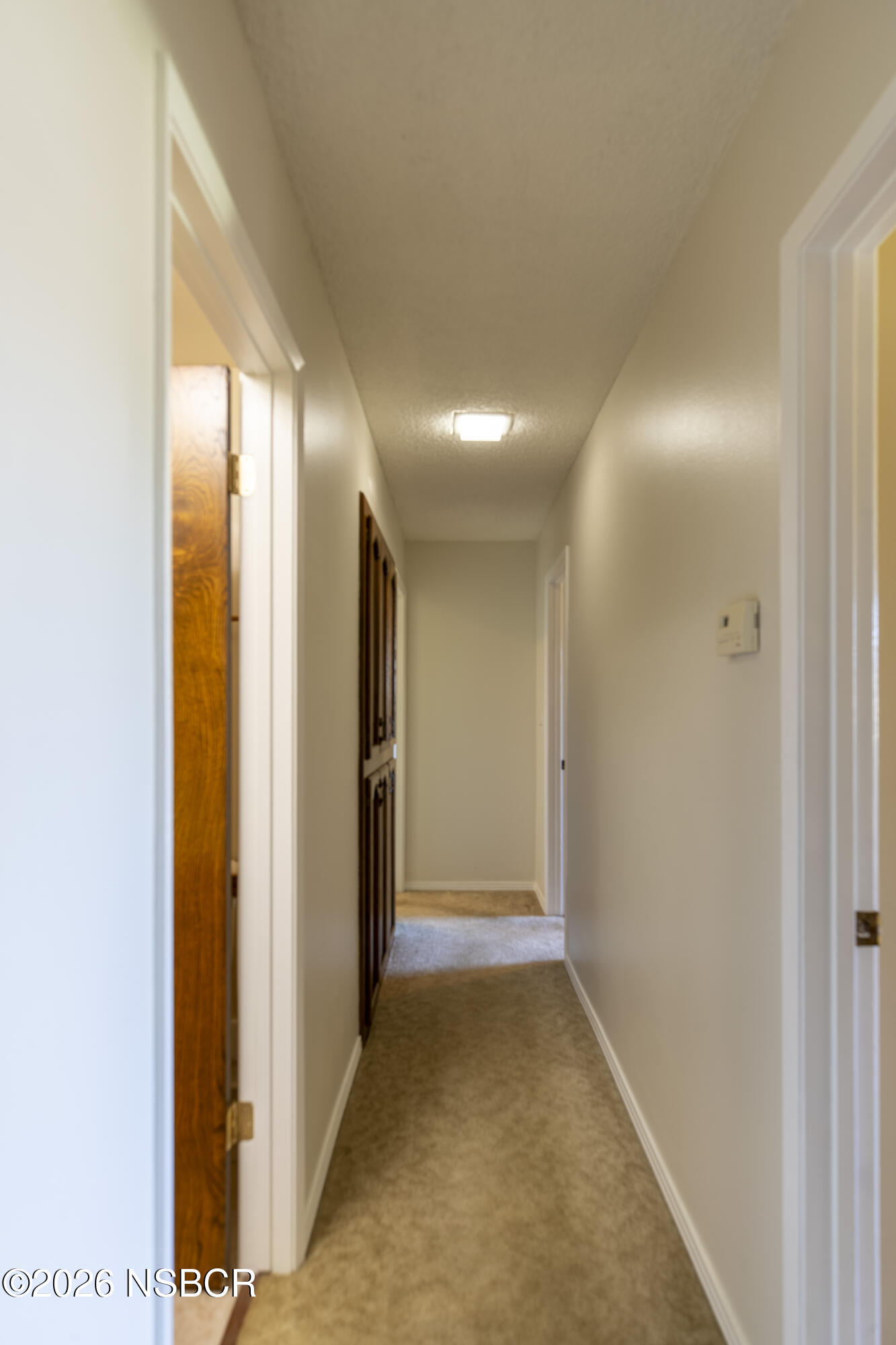 205 South E Street Lompoc, CA 93436 - Photo 20 of 49 a view of hallway with a large window and carpet