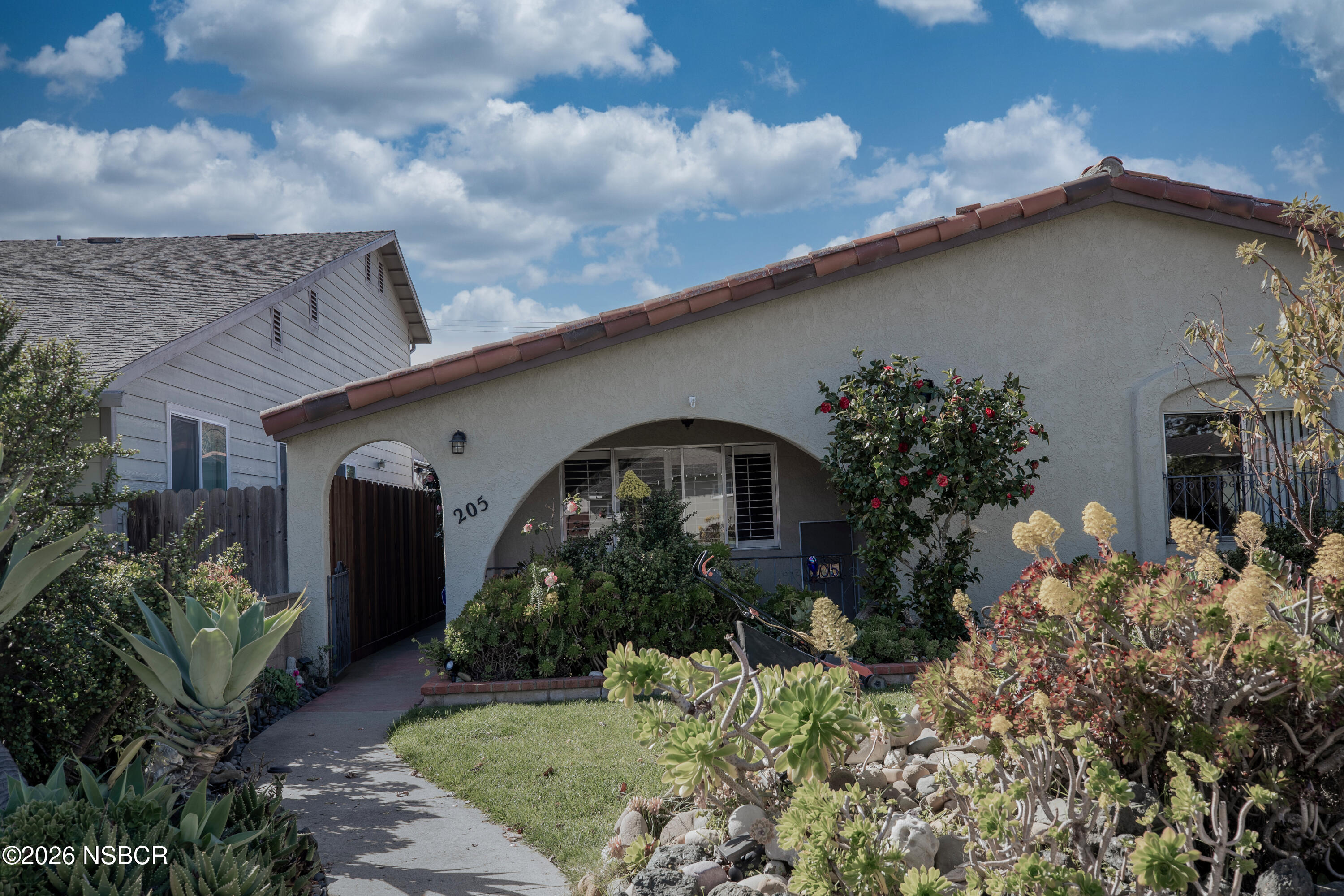 205 South E Street Lompoc, CA 93436 - Photo 2 of 49 front view of house with potted plants