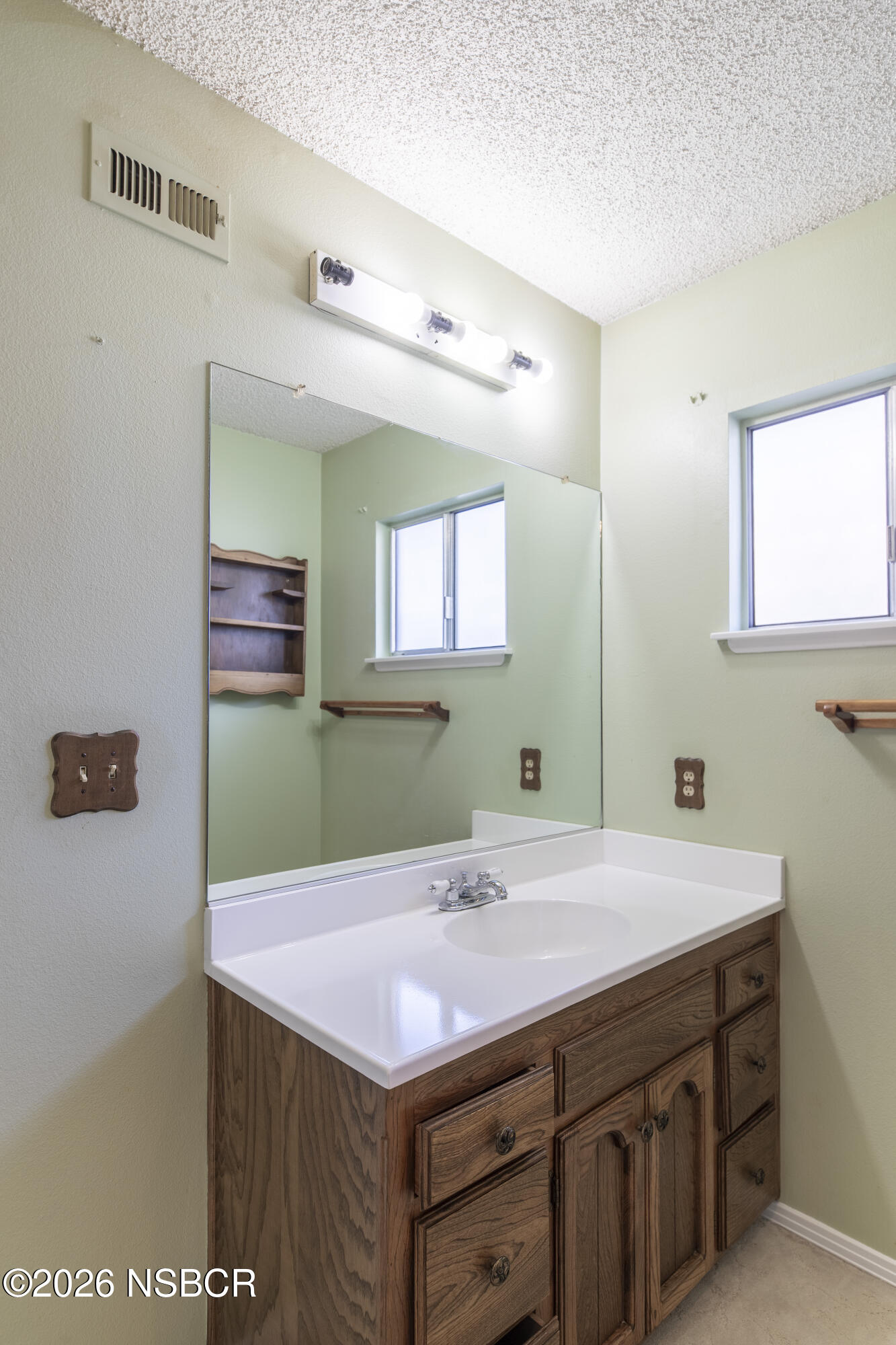 205 South E Street Lompoc, CA 93436 - Photo 22 of 49 a bathroom with a sink and a mirror