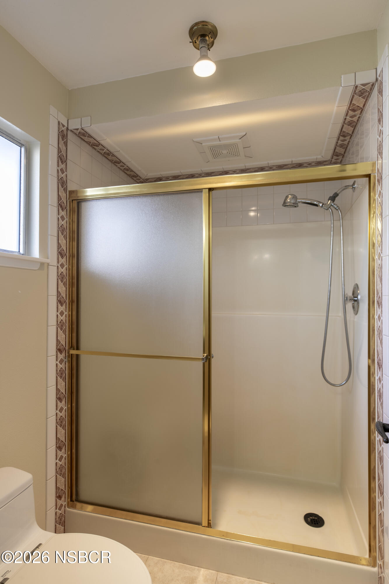 205 South E Street Lompoc, CA 93436 - Photo 23 of 49 a bathroom with a glass shower door