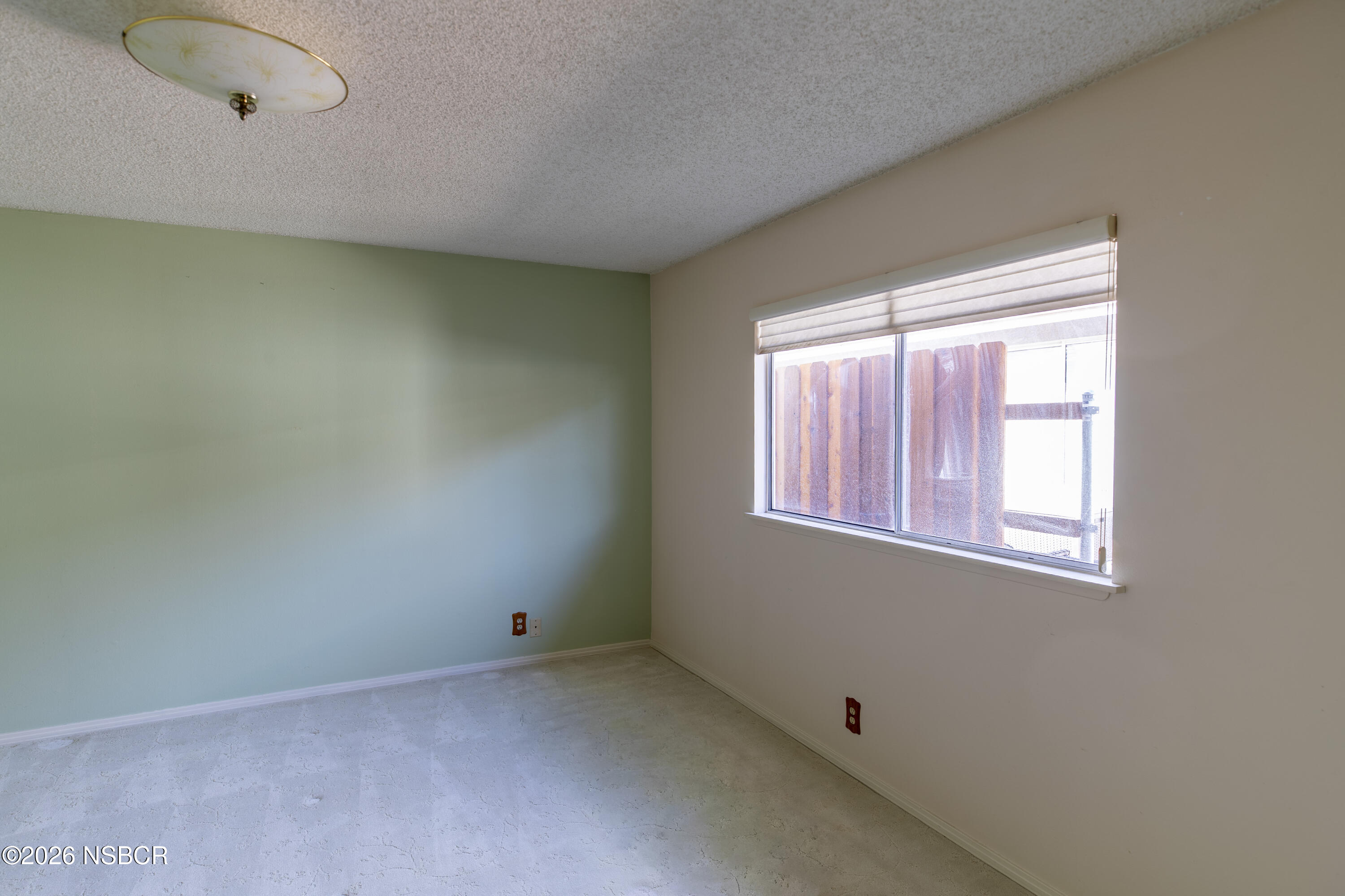 205 South E Street Lompoc, CA 93436 - Photo 25 of 49 a view of an empty room with a window