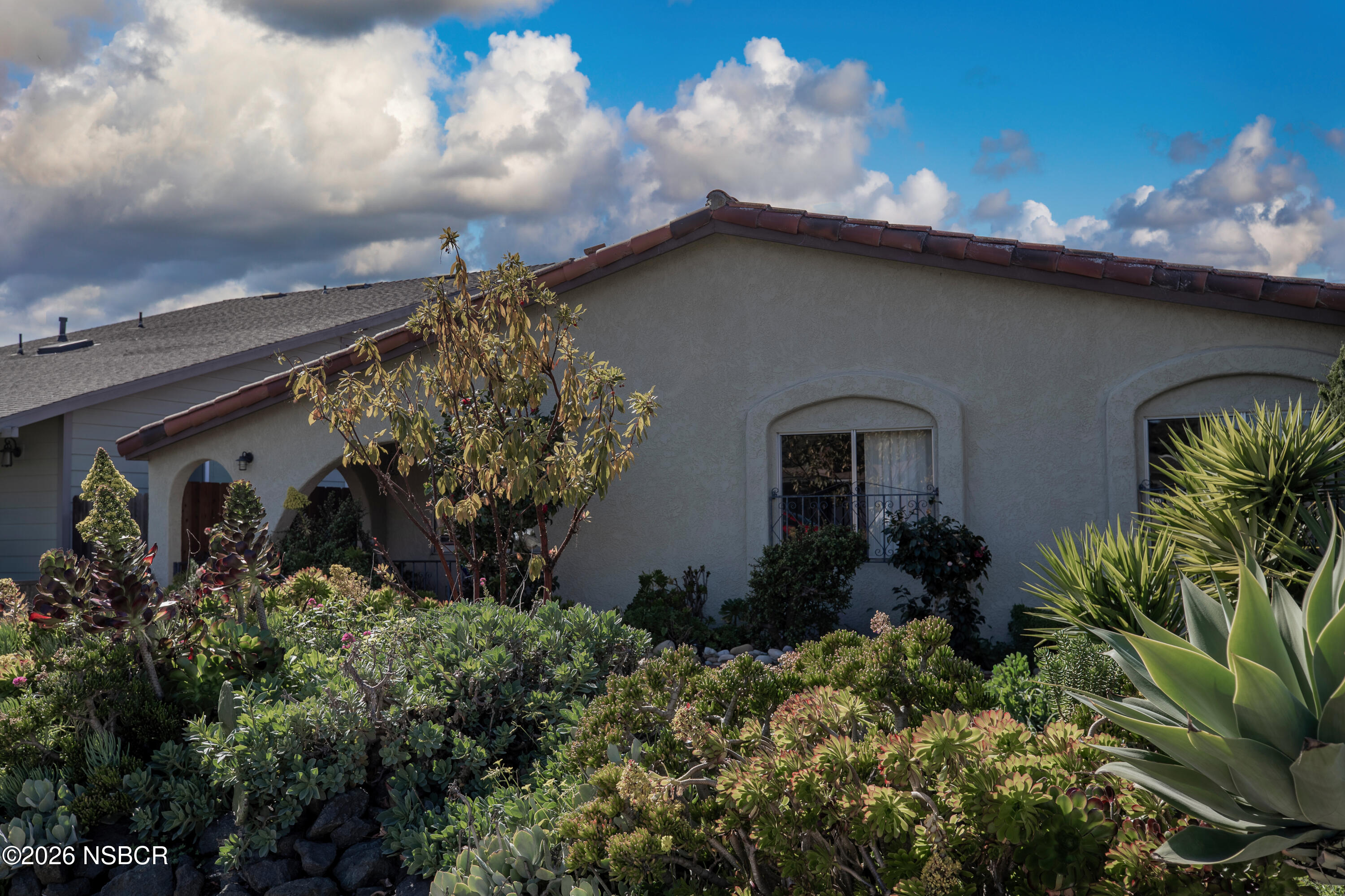 205 South E Street Lompoc, CA 93436 - Photo 3 of 49 a backyard of a house with lots of green space