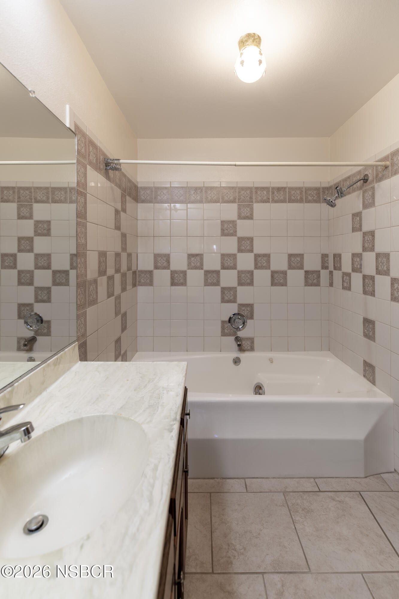 205 South E Street Lompoc, CA 93436 - Photo 32 of 49 a bathroom with a bathtub and shower