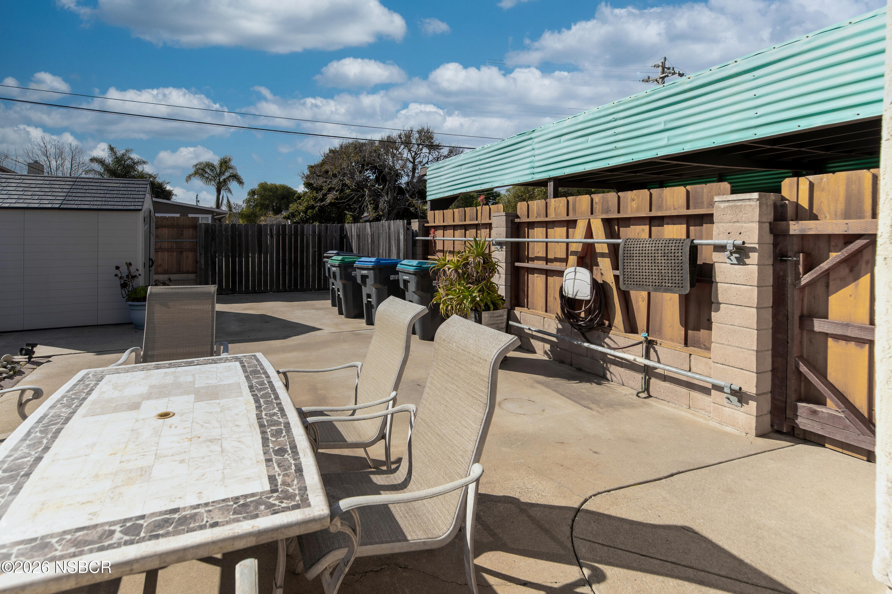 205 South E Street Lompoc, CA 93436 - Photo 35 of 49 a view of a patio with table and chairs and potted plants