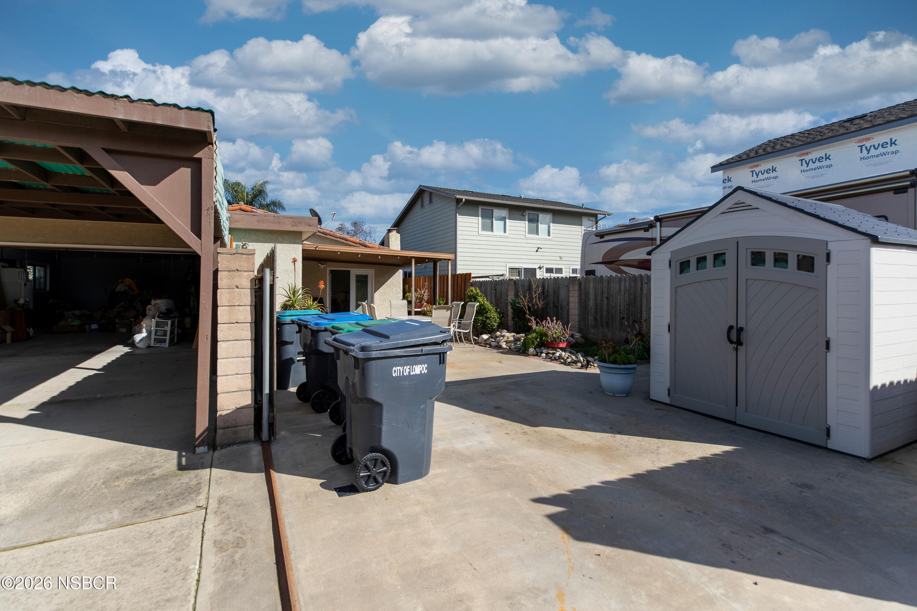 205 South E Street Lompoc, CA 93436 - Photo 38 of 49 a view of a patio with table and chairs and floor to ceiling window