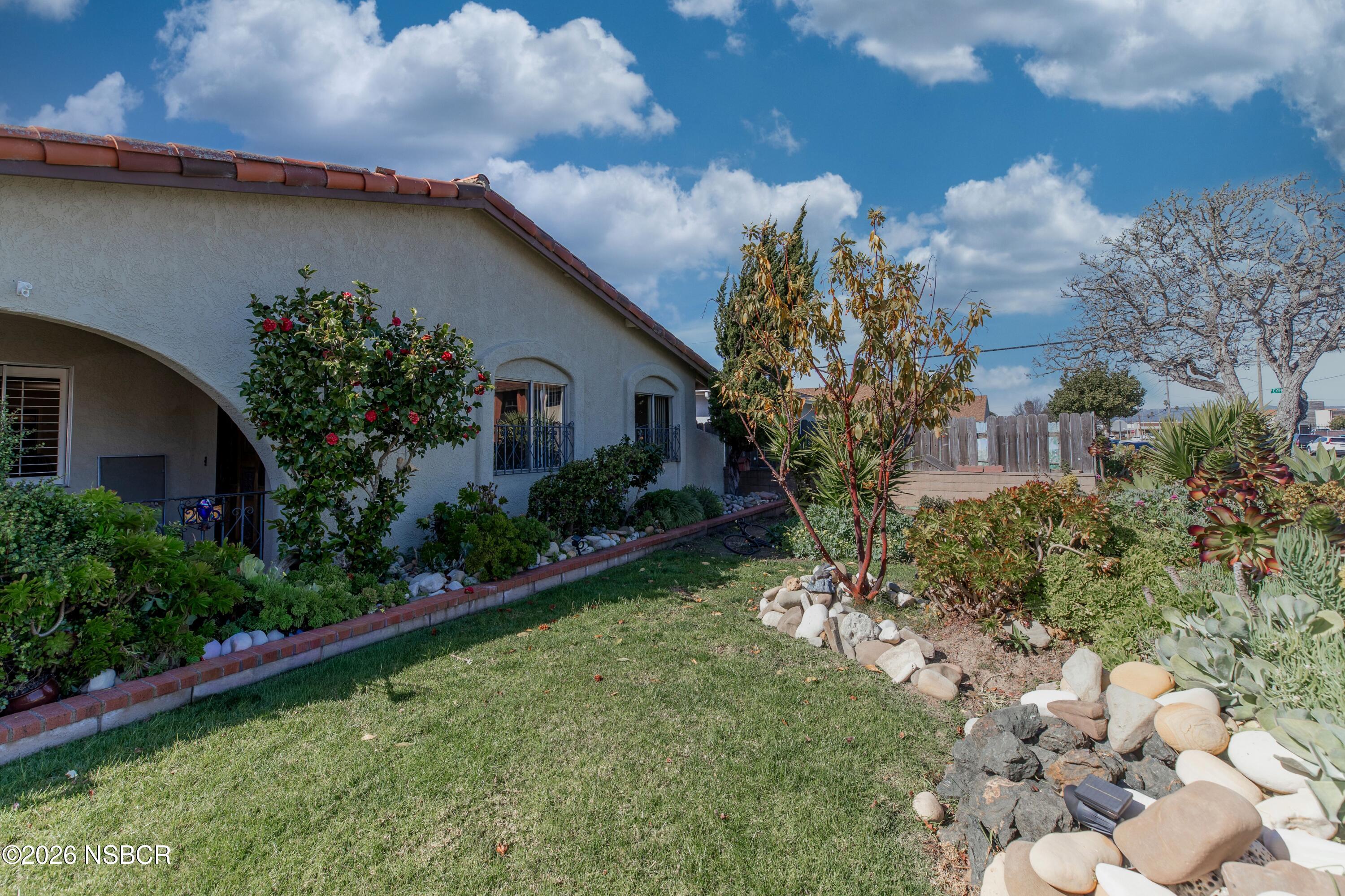 205 South E Street Lompoc, CA 93436 - Photo 4 of 49 a house with garden in front of it