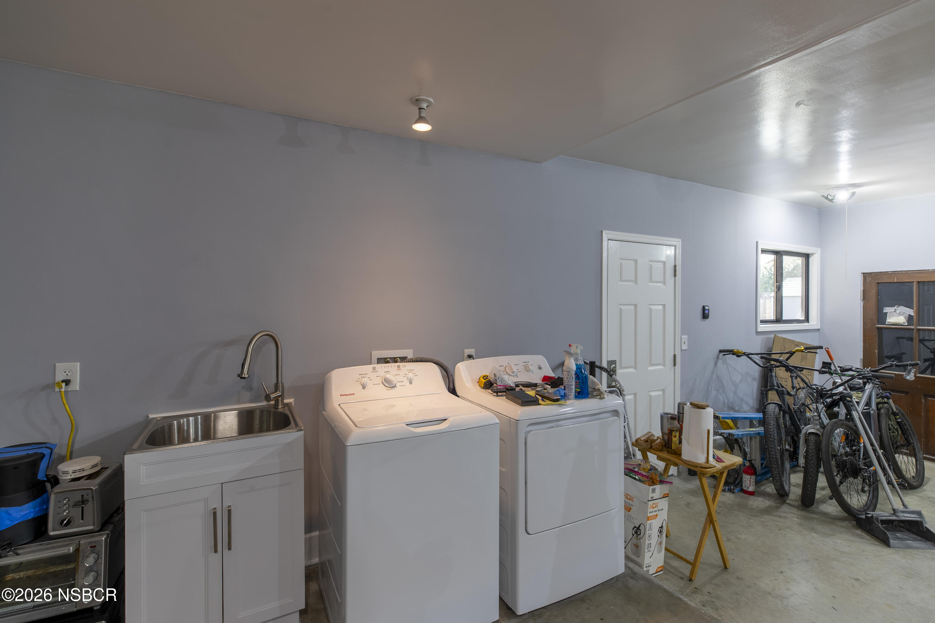 205 South E Street Lompoc, CA 93436 - Photo 46 of 49 a storage room with washer and dryer