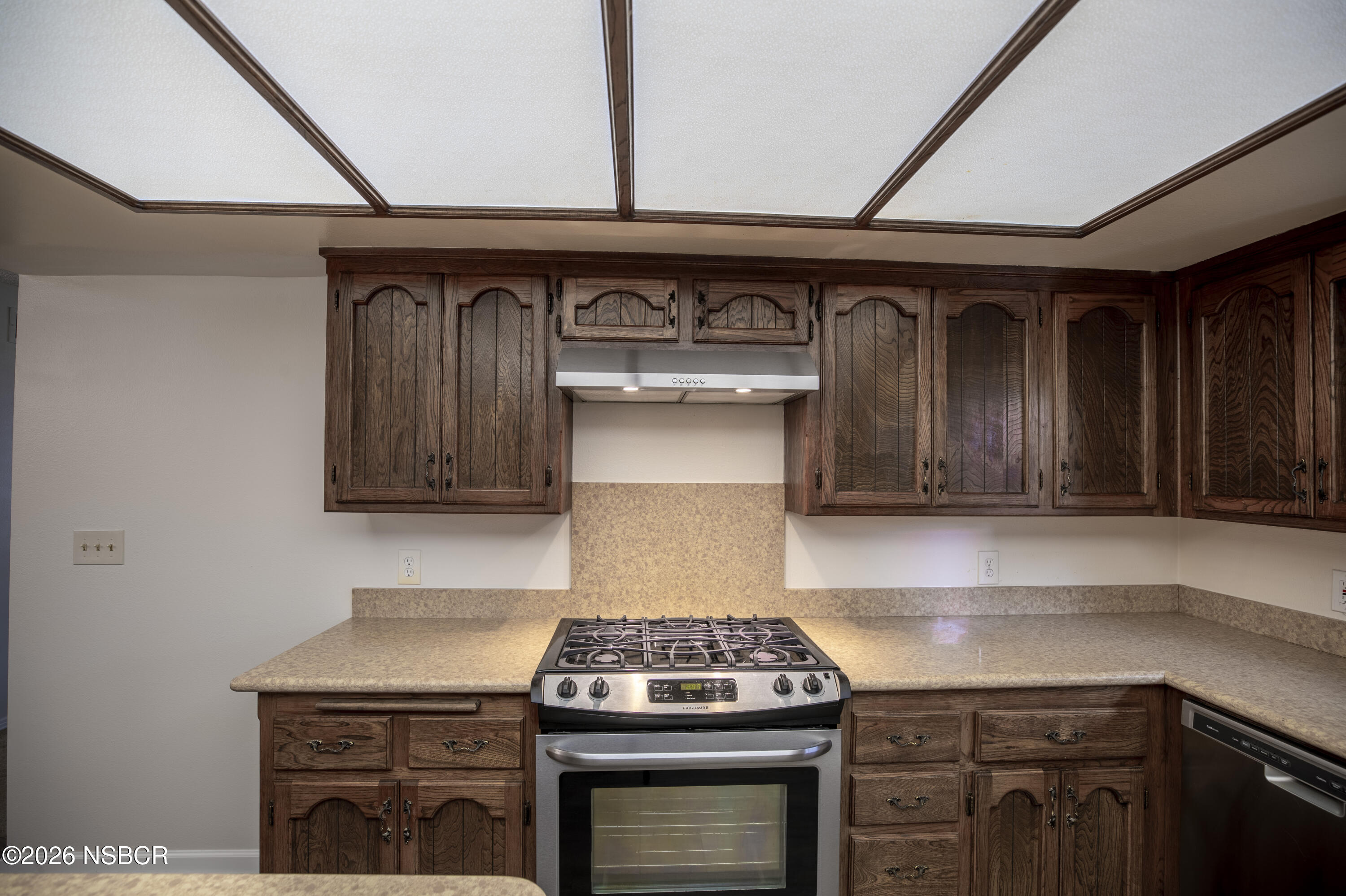 205 South E Street Lompoc, CA 93436 - Photo 10 of 49 a kitchen with granite countertop a stove and a sink
