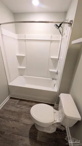 a bathroom with a toilet and a shower