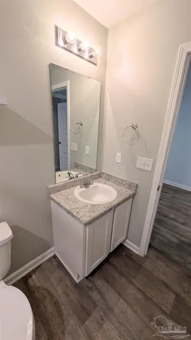 a bathroom with a granite countertop sink and a mirror