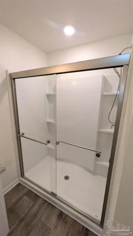a bathroom with a glass shower door
