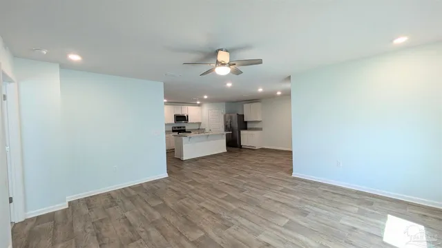 a view of a kitchen with a sink and a refrigerator