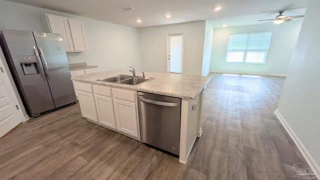 a kitchen with wooden floors and cabinets