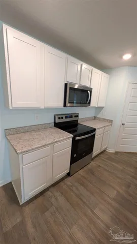 a kitchen with granite countertop a stove and a sink