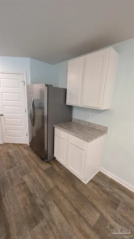 a view of a kitchen with refrigerator and cabinet