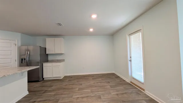 a view of a kitchen with a sink and a refrigerator