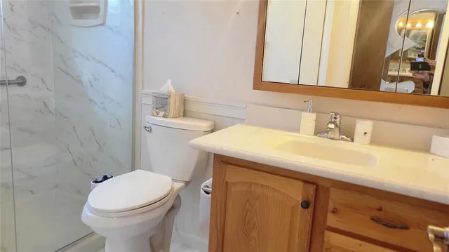 a bathroom with a sink a toilet and mirror