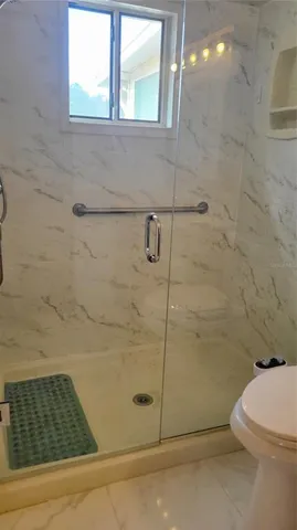 a bathroom with a toilet and a shower