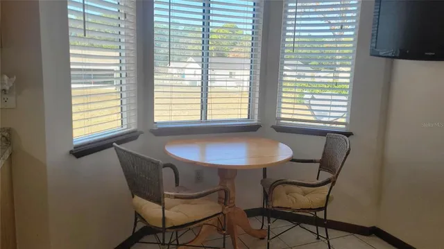 a view of a room that has a window and chair