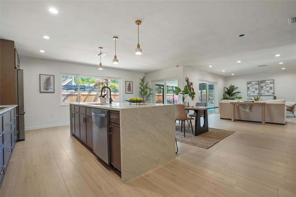 2370 Robyn Court Dunedin, FL 34698 - Photo 11 of 37 a kitchen with stainless steel appliances granite countertop a stove and a refrigerator