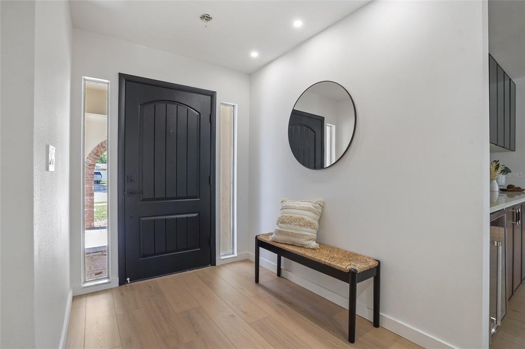 2370 Robyn Court Dunedin, FL 34698 - Photo 15 of 37 a view of a hallway with wooden floor and a bathroom