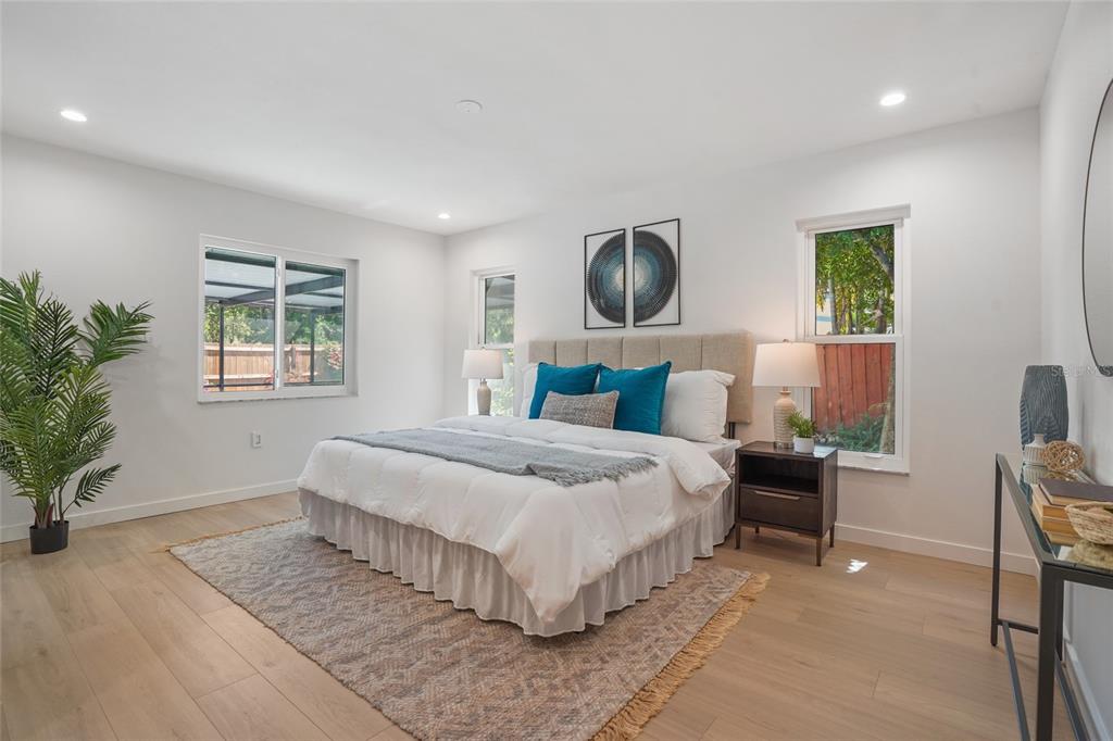 2370 Robyn Court Dunedin, FL 34698 - Photo 16 of 37 a bedroom with a large bed and a window