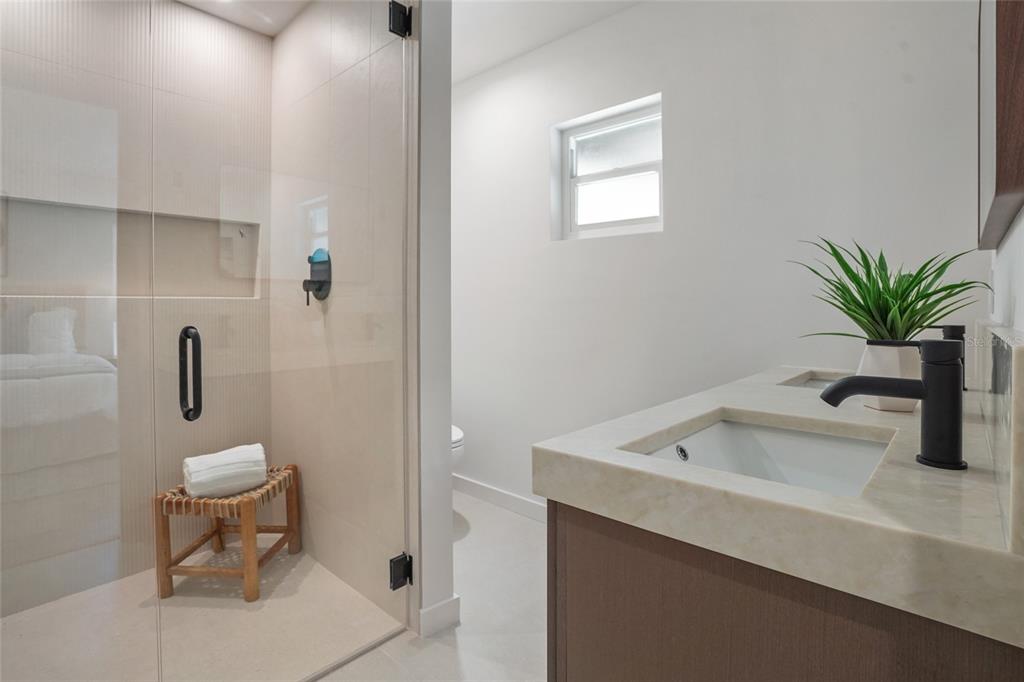 2370 Robyn Court Dunedin, FL 34698 - Photo 19 of 37 a bathroom with a sink toilet and a mirror