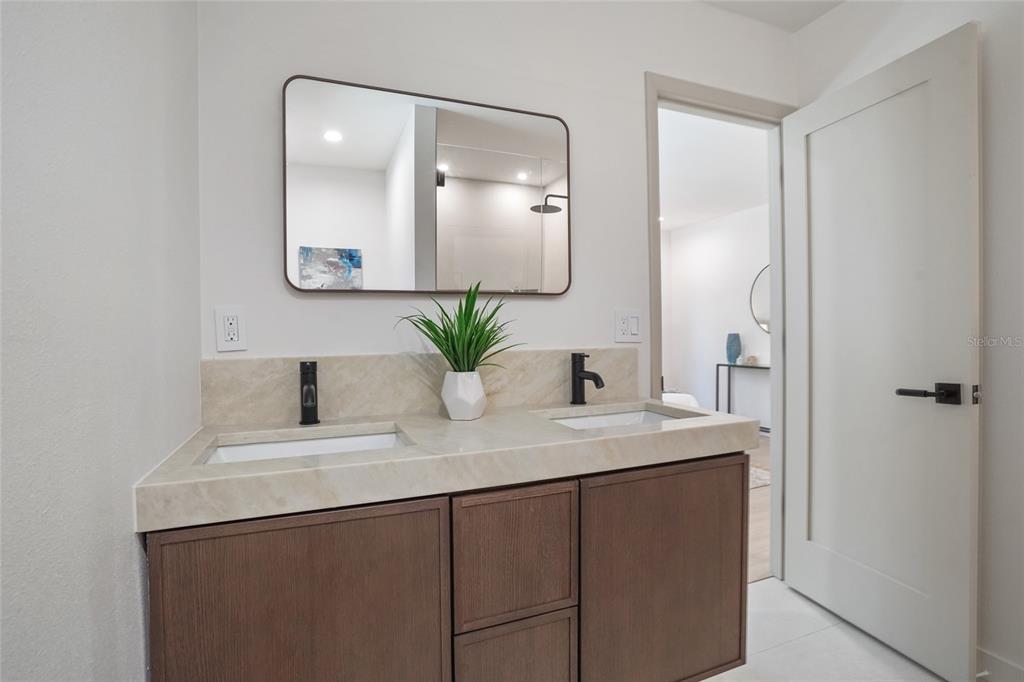 2370 Robyn Court Dunedin, FL 34698 - Photo 21 of 37 a bathroom with a granite countertop sink and a mirror