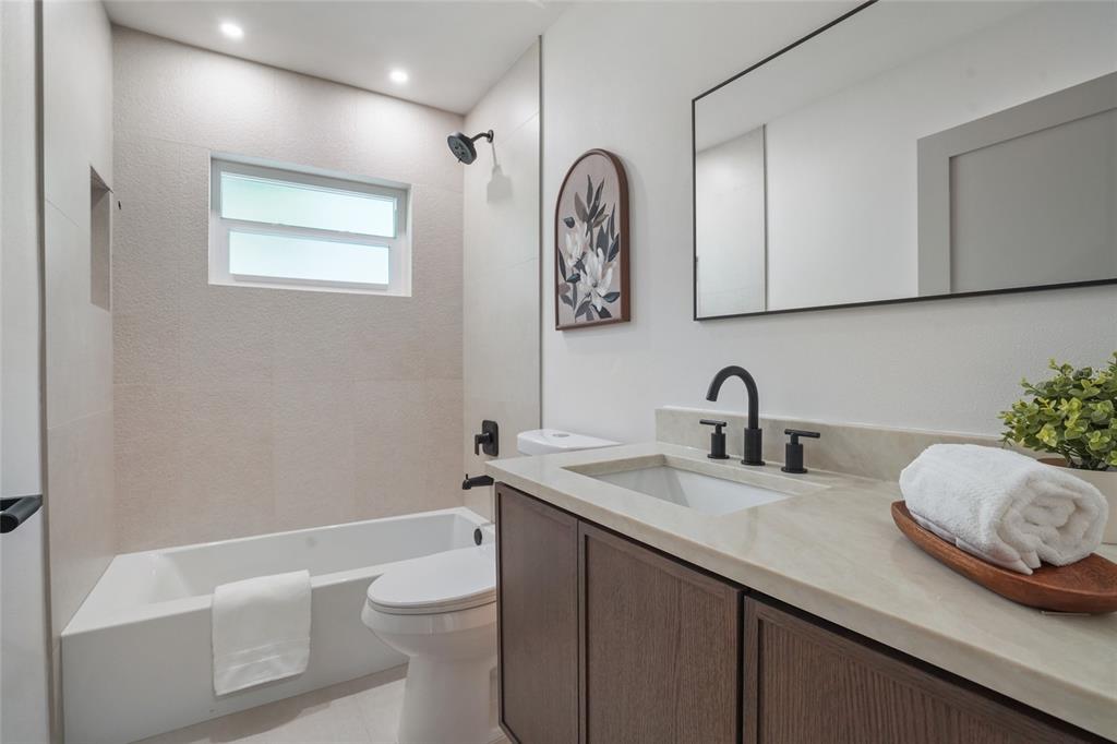 2370 Robyn Court Dunedin, FL 34698 - Photo 25 of 37 a bathroom with a granite countertop sink mirror vanity and toilet