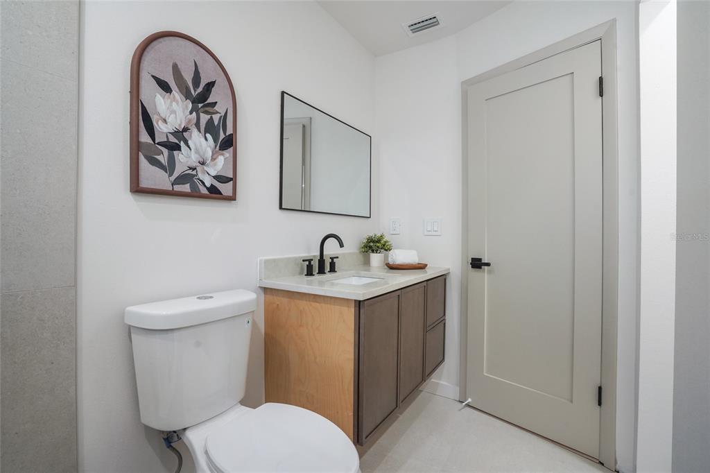 2370 Robyn Court Dunedin, FL 34698 - Photo 26 of 37 a bathroom with a toilet a sink and mirror