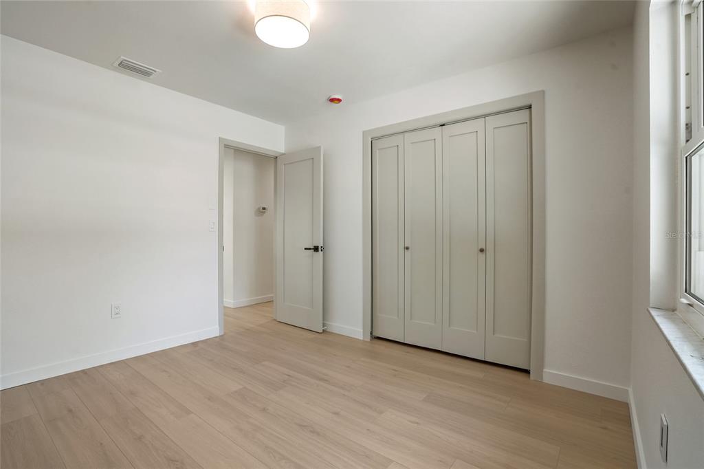 2370 Robyn Court Dunedin, FL 34698 - Photo 29 of 37 a view of an empty room and wooden floor