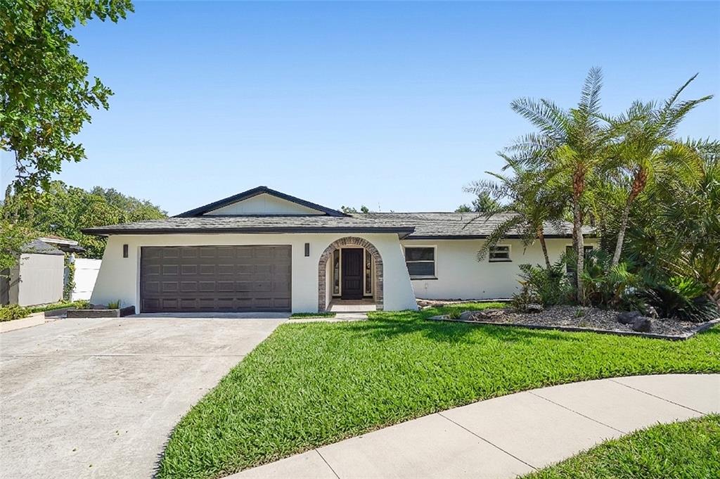 2370 Robyn Court Dunedin, FL 34698 - Photo 37 of 37 a front view of a house with a yard and garage